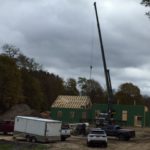Crane placing roof trusses