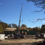 Crane placing roof trusses