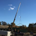 Crane placing roof trusses
