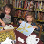 Children making pasta snowflakes
