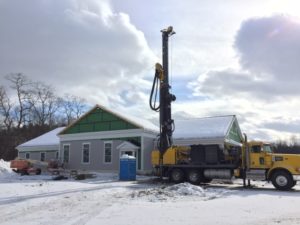 Well digger in front of new library building