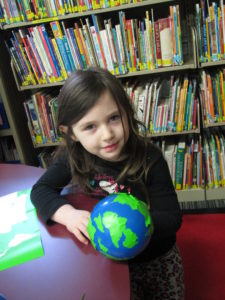 Girl holding handmade globe