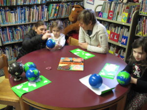 Children at table making globes