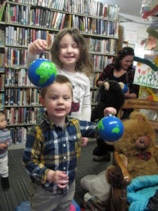 Children playing with handmade globes