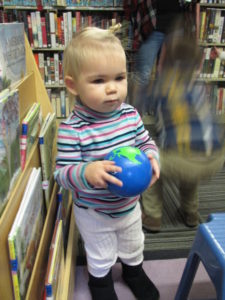 Baby holding handmade globe
