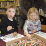 2 kids doing crafts at Story Time