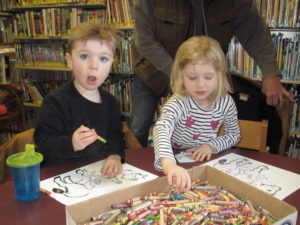 2 kids doing crafts at Story Time