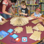 children making large paper stars