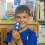 boy showing his lego vehicle