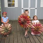 3 children holding large paper stars