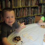 boy and girl making and eating bird treats