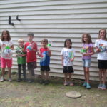 Kids showing the bottle rockets they made.