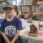 Boy with decorated bird house