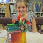 Girl holding decorated bird house