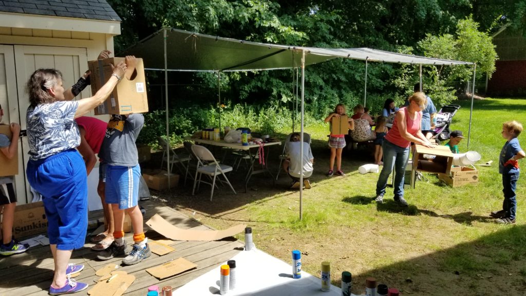 Kids & adults making space suits from boxes etc. 